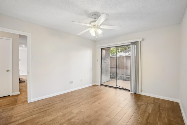 unfurnished room featuring ceiling fan, a textured ceiling, baseboards, and light wood-style floors