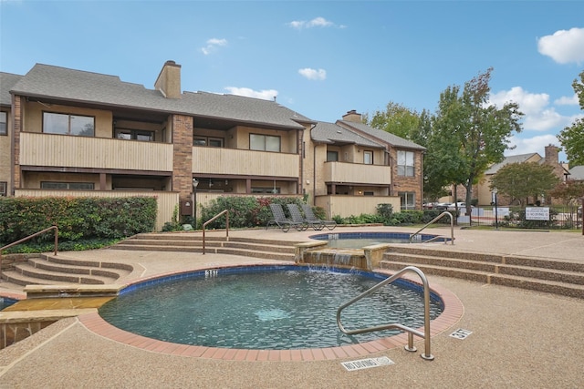 community pool with a patio area