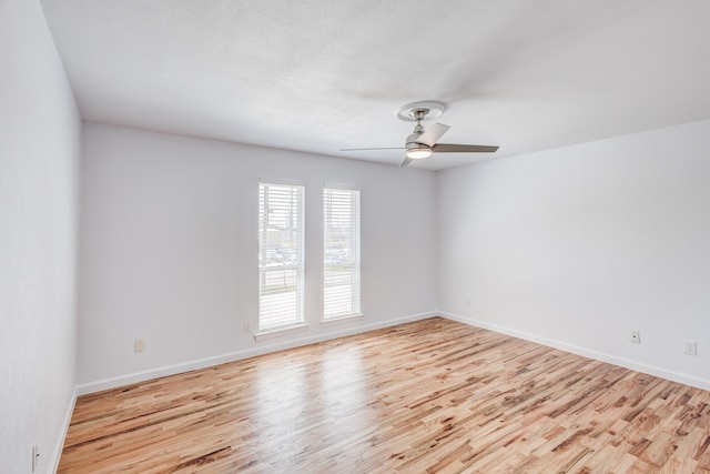 spare room featuring light hardwood / wood-style floors and ceiling fan