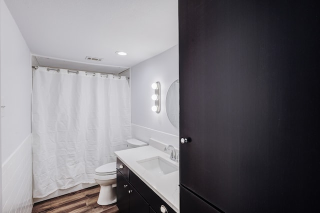 bathroom with a shower with curtain, vanity, toilet, and wood-type flooring