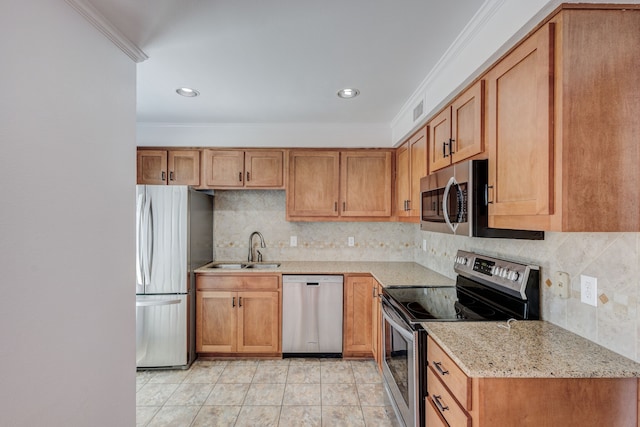 kitchen with sink, decorative backsplash, ornamental molding, light stone counters, and stainless steel appliances