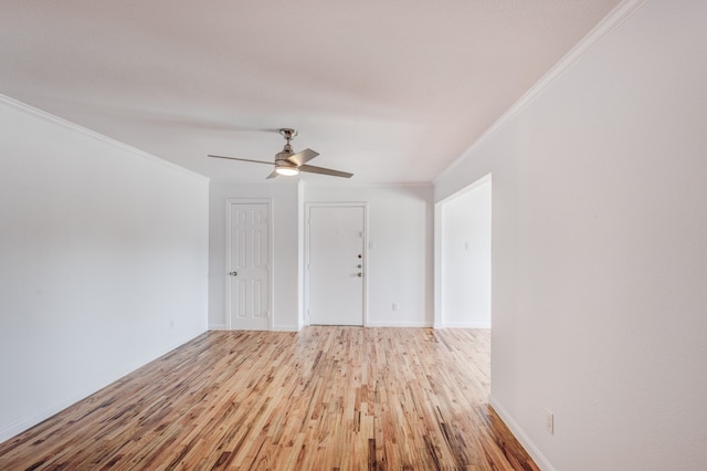 spare room with light hardwood / wood-style flooring, ceiling fan, and crown molding