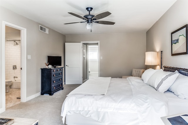 bedroom featuring light carpet, connected bathroom, and ceiling fan