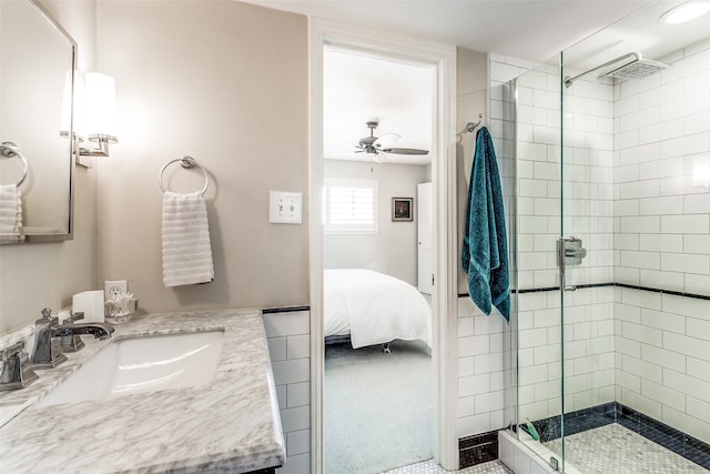 bathroom featuring walk in shower, ceiling fan, and vanity