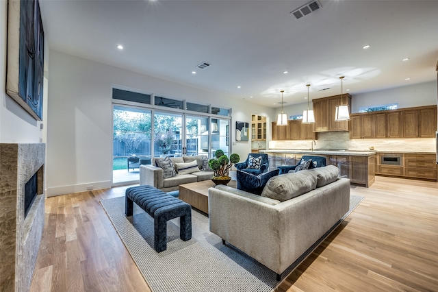 living room featuring light hardwood / wood-style floors and a fireplace