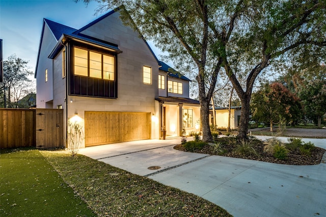 view of front of property with a garage and a front lawn