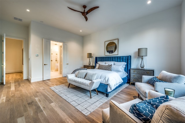 bedroom with ensuite bath, ceiling fan, and light wood-type flooring