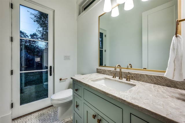 bathroom featuring tile patterned floors, vanity, and toilet