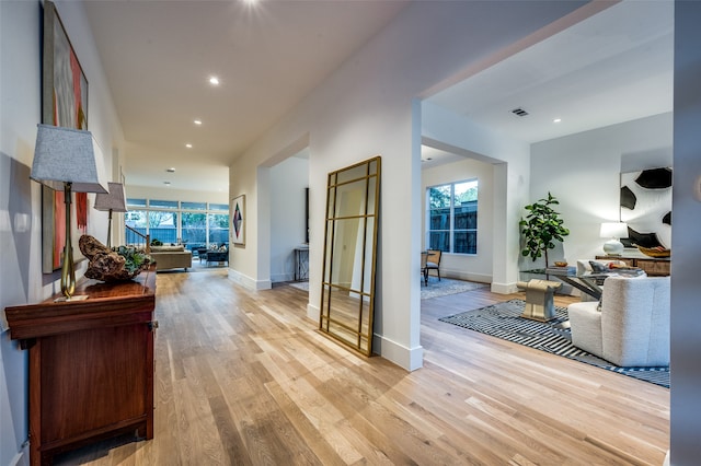 corridor featuring plenty of natural light and light hardwood / wood-style floors