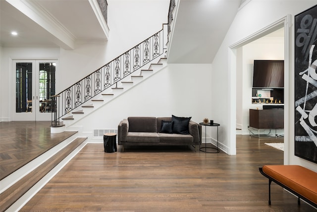 interior space with wood-type flooring, crown molding, and french doors