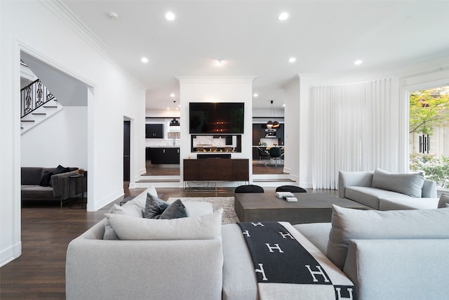 living room with dark wood-type flooring and ornamental molding