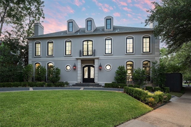 french provincial home with a yard