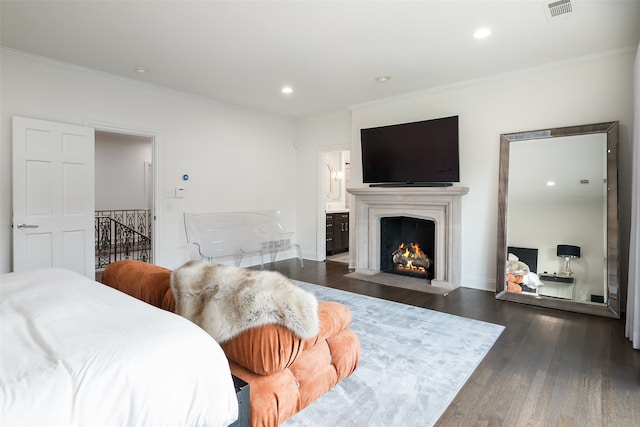 bedroom with dark hardwood / wood-style flooring, ensuite bathroom, and ornamental molding