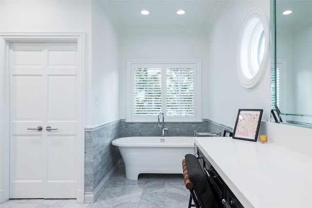 bathroom with crown molding, tile walls, and a bathing tub