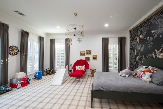 bedroom featuring crown molding and multiple windows