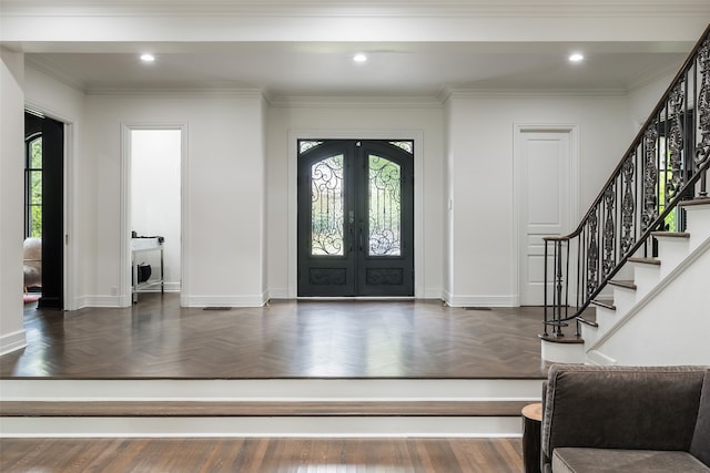 entryway with dark parquet flooring, french doors, and a healthy amount of sunlight