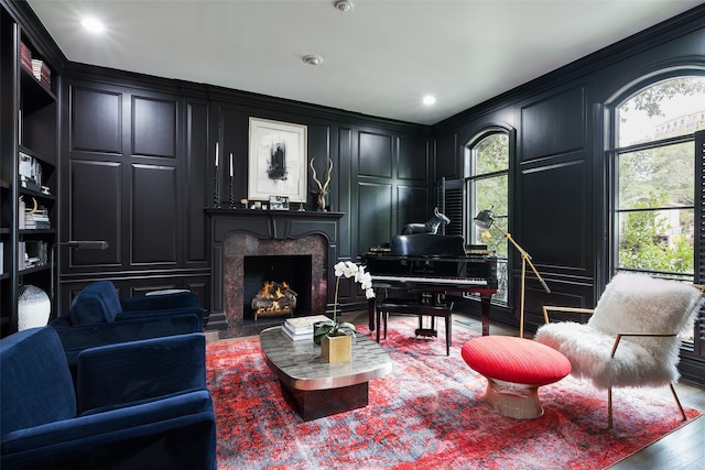 sitting room featuring crown molding, a fireplace, and hardwood / wood-style flooring