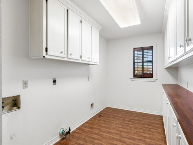 laundry room with dark wood-type flooring, cabinets, washer hookup, and hookup for an electric dryer