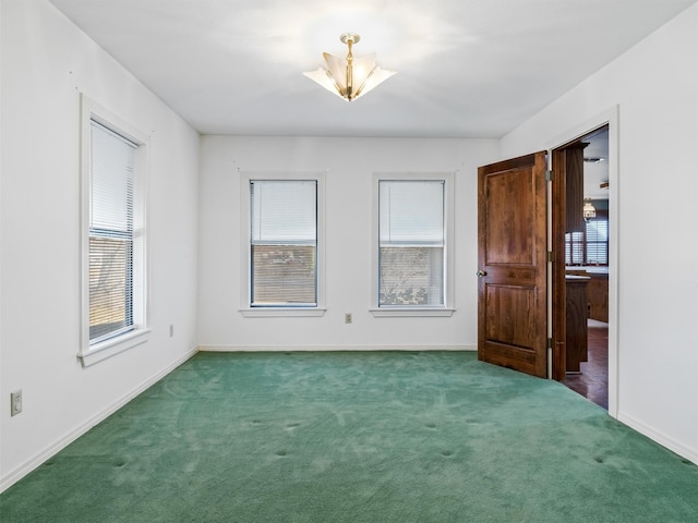 spare room with dark colored carpet