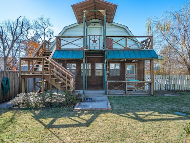 back of house with a yard and a patio area