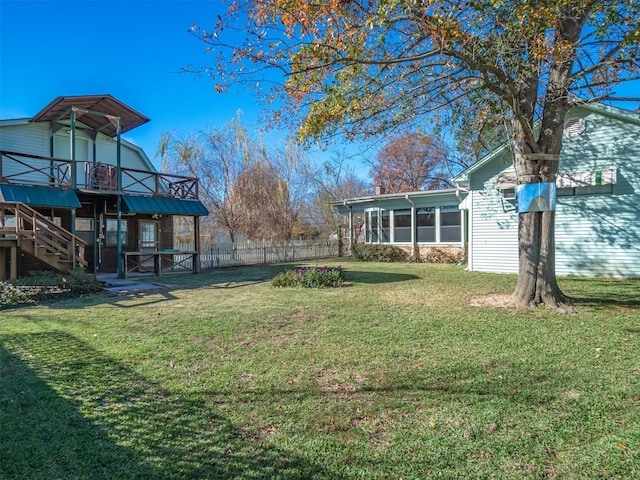 view of yard featuring a sunroom and a deck