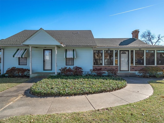 ranch-style home featuring a front yard