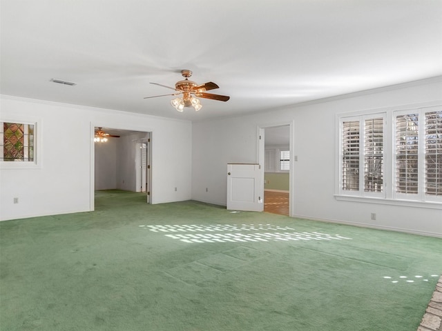 carpeted empty room featuring crown molding and ceiling fan