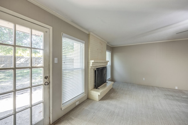 unfurnished living room featuring light carpet, a brick fireplace, and crown molding