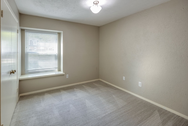 unfurnished room featuring light colored carpet