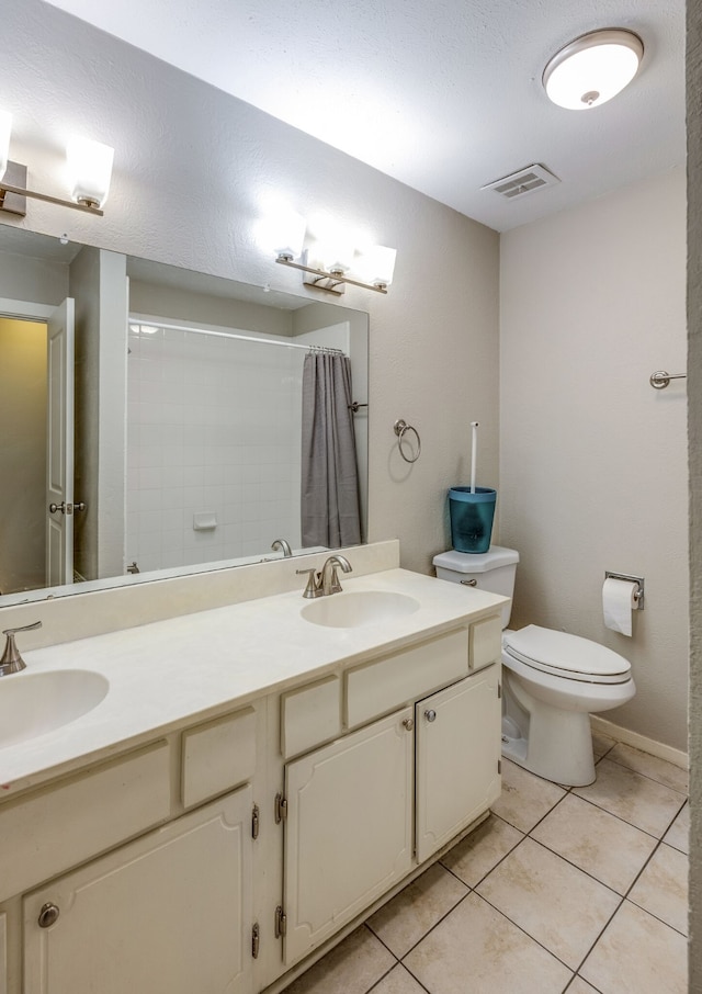 bathroom with tile patterned flooring, a shower with curtain, toilet, and vanity