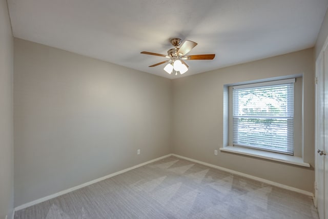 unfurnished room with light carpet and ceiling fan