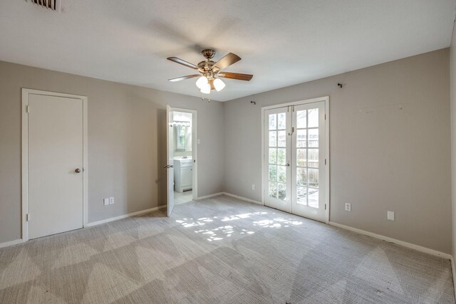 unfurnished room with ceiling fan, french doors, light colored carpet, and washer / dryer