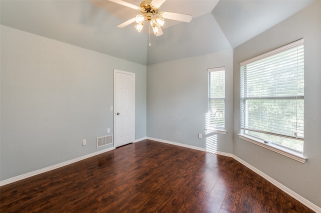 empty room with ceiling fan, lofted ceiling, and dark hardwood / wood-style flooring