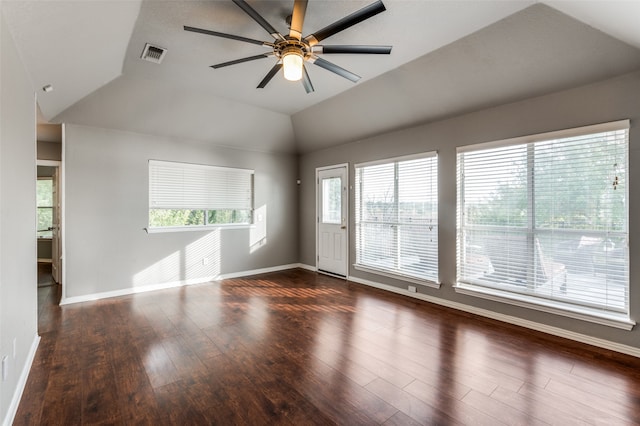 spare room with dark wood-type flooring, vaulted ceiling, and ceiling fan