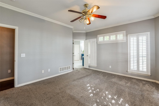 carpeted spare room with ceiling fan and ornamental molding