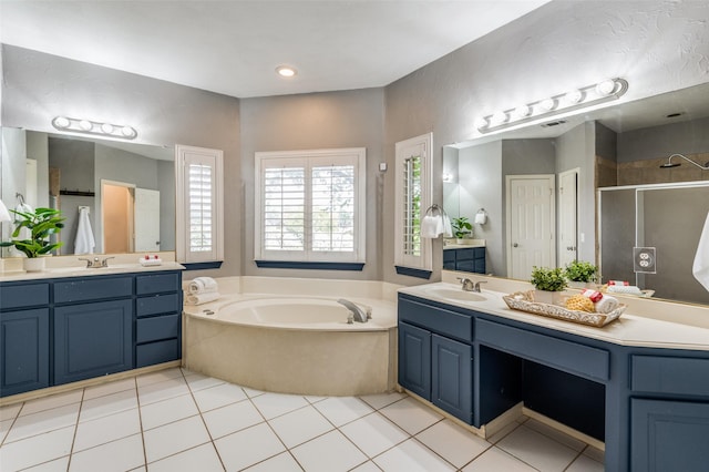 bathroom with tile patterned flooring, vanity, and separate shower and tub