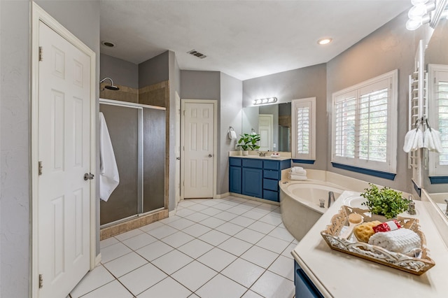 bathroom featuring plus walk in shower, tile patterned floors, and vanity