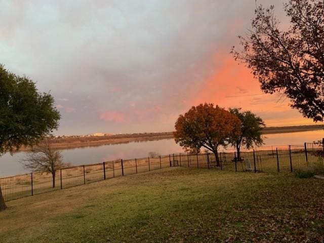 yard at dusk with a water view