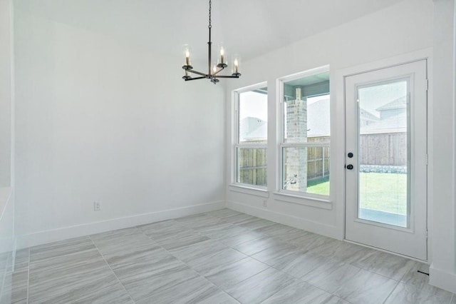 unfurnished dining area with an inviting chandelier