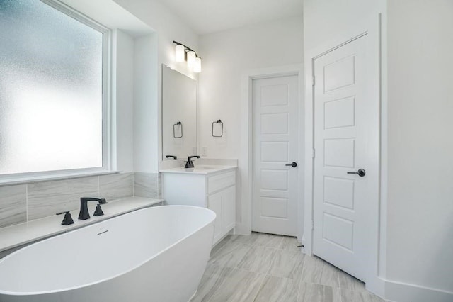 bathroom featuring vanity and a tub to relax in