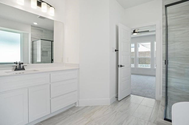 bathroom with ceiling fan, vanity, and a shower with shower door