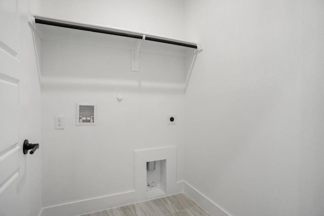 laundry area featuring electric dryer hookup, gas dryer hookup, hookup for a washing machine, and light hardwood / wood-style flooring