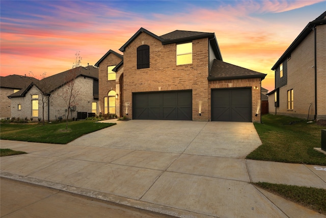 view of front of home featuring a yard and a garage