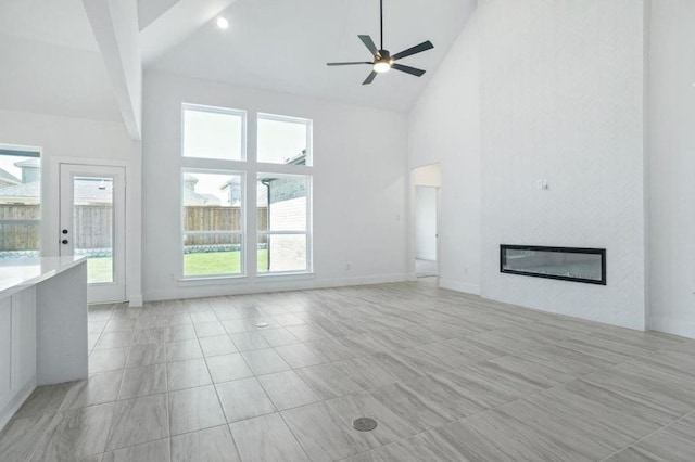 unfurnished living room featuring beamed ceiling, ceiling fan, light tile patterned floors, and high vaulted ceiling