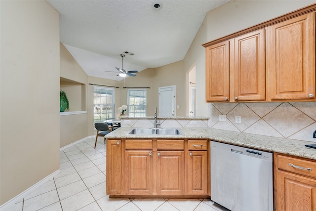 kitchen featuring tasteful backsplash, a textured ceiling, sink, dishwasher, and lofted ceiling