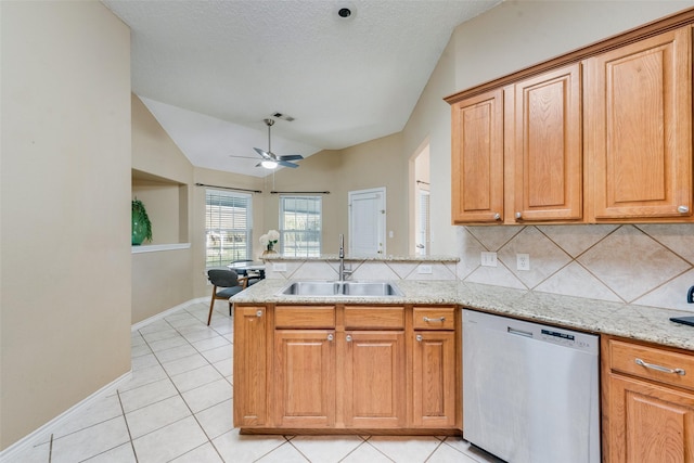 kitchen featuring tasteful backsplash, dishwasher, sink, light tile patterned floors, and kitchen peninsula