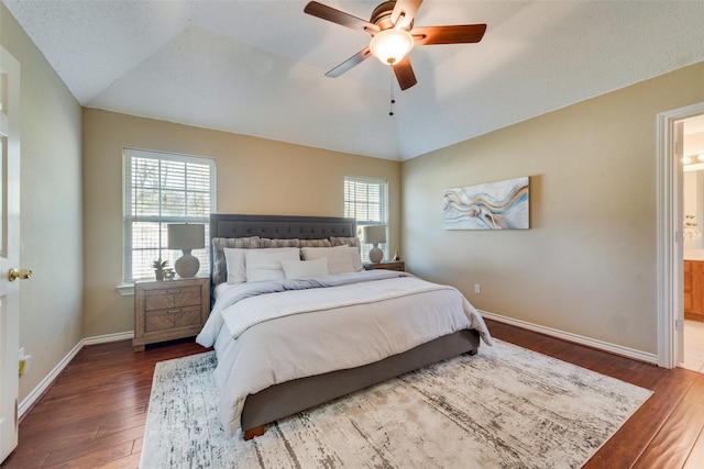 bedroom with lofted ceiling, ensuite bath, wood-type flooring, and ceiling fan