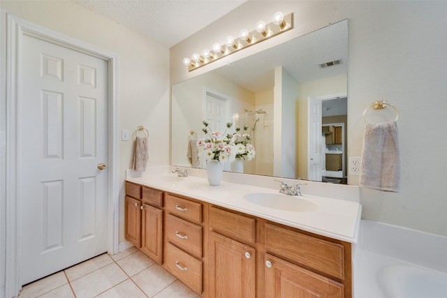 bathroom featuring walk in shower, vanity, tile patterned flooring, and a textured ceiling