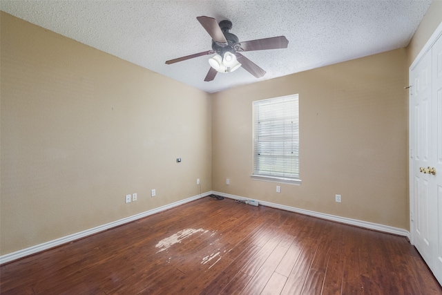 unfurnished room with dark hardwood / wood-style floors, ceiling fan, and a textured ceiling