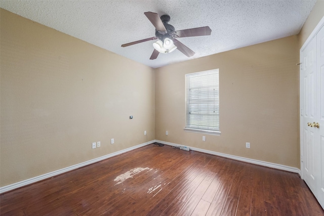 unfurnished room featuring ceiling fan, dark hardwood / wood-style floors, and a textured ceiling